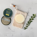 Flay lay of the solid silk conditioning bar lying on organic cotton.