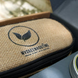 Close-up of a burlap pouch with 'My Green Routine' branding on a blurred natural background.