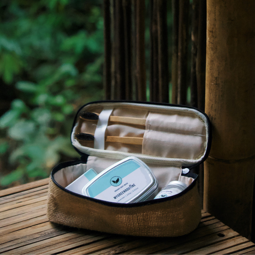 Open brown travel case with toiletries on a wooden surface outdoors