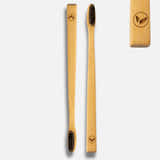 Two bamboo toothbrushes with black bristles on a white background