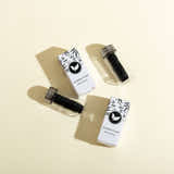 Two bamboo floss containers with packaging on a beige background