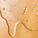 Close-up of a natural liquid with bubbles as part of the natural ingredients list.