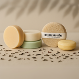 Natural and organic hair and body bars laid out in studio lighting.