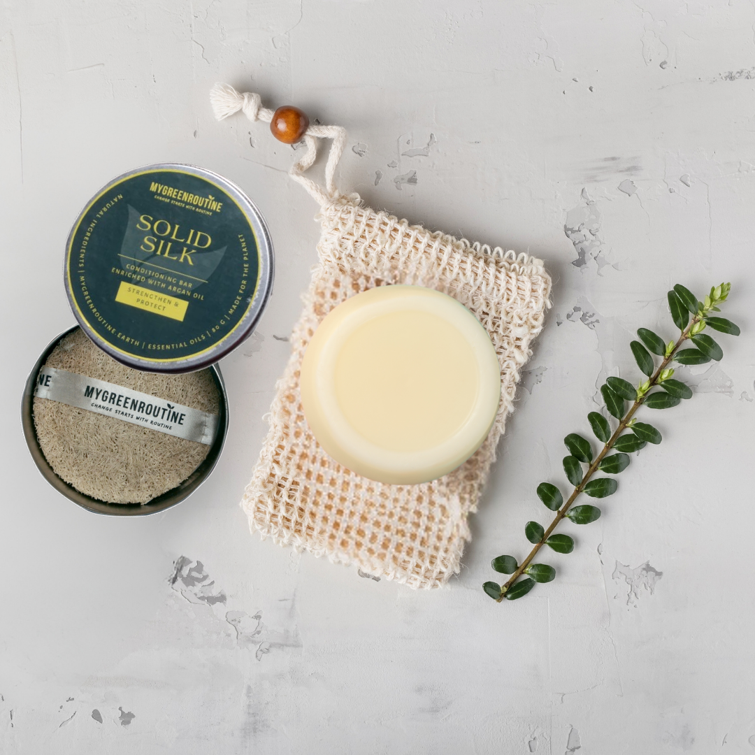 Flay lay of the solid silk conditioning bar lying on organic cotton. 
