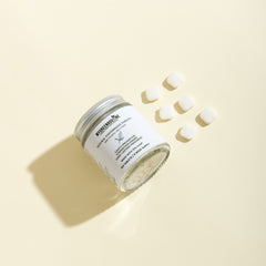 Jar of cream with a label on a beige background