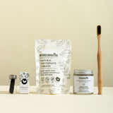 MyGreenRoutine natural toothpaste tablets, jar, and bamboo toothbrush on a beige background