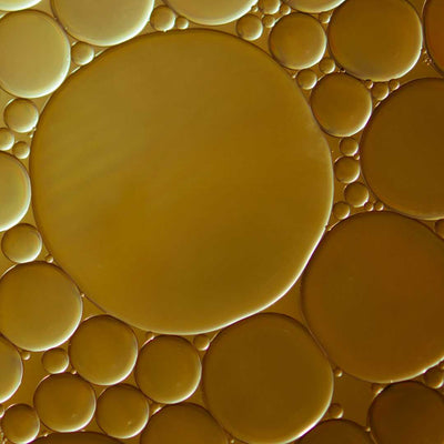 Close-up of yellow bubbles on a yellow background as part of the natural ingredients list.