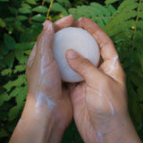 Natural organic and toxin free solid hair and body product lathering in females hands in nature