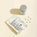 Packaging of natural toothpaste tablets with a container on a beige background